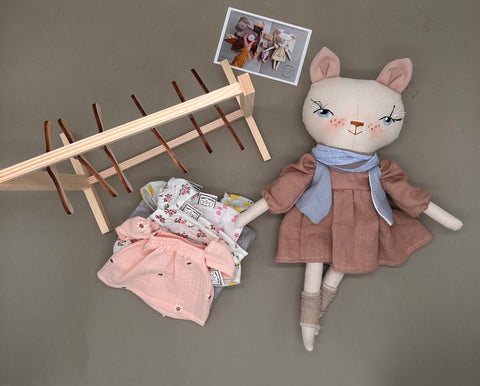 Doll + 2 boxes of clothes and a stand